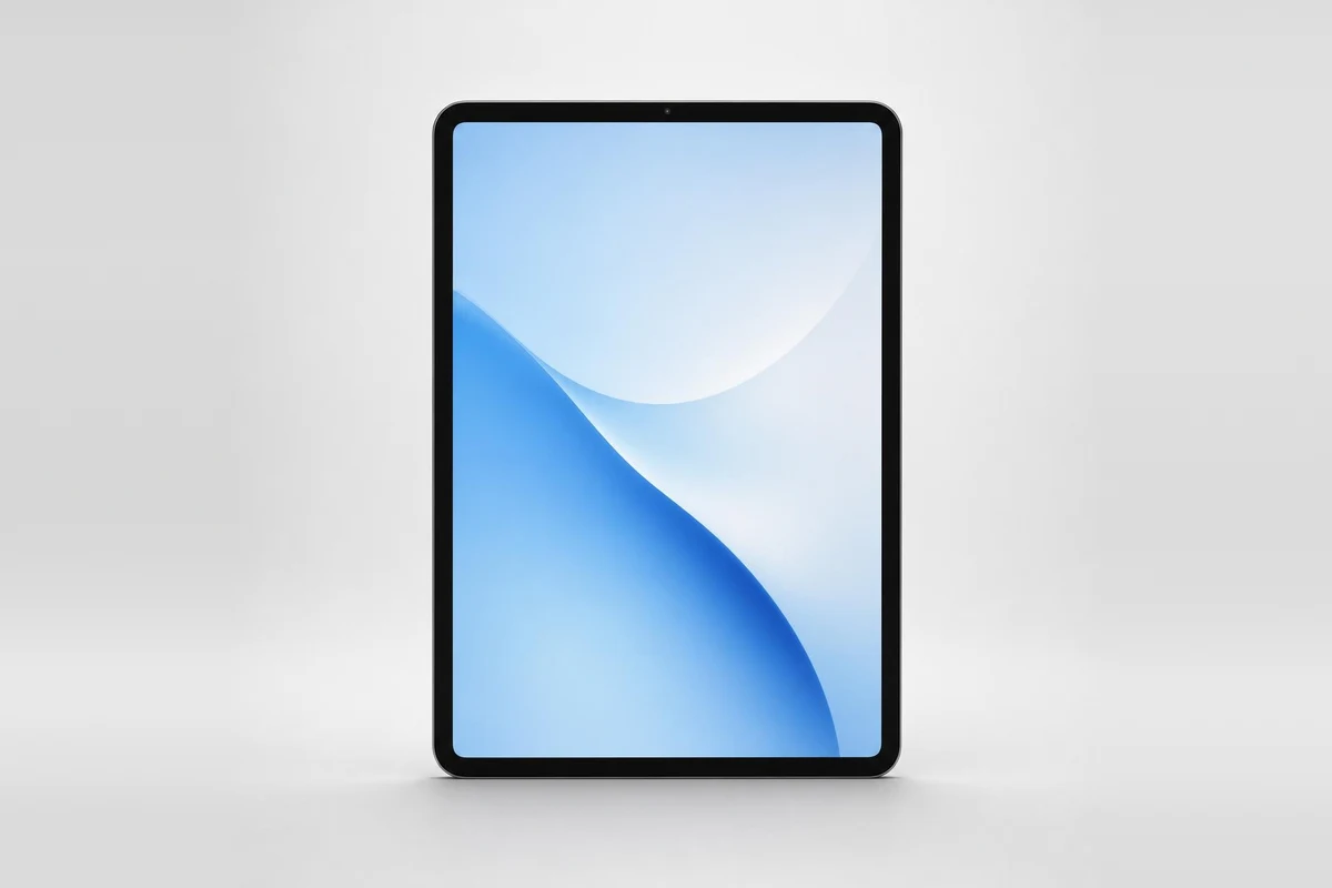 Silver iPad with a blue wave wallpaper standing upright on a soft light gray background
